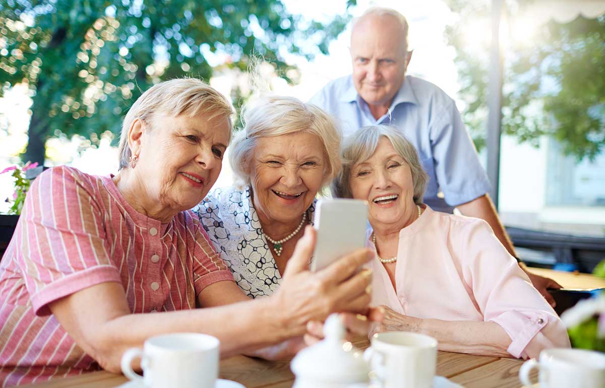 elderly people in aged care taking a photo