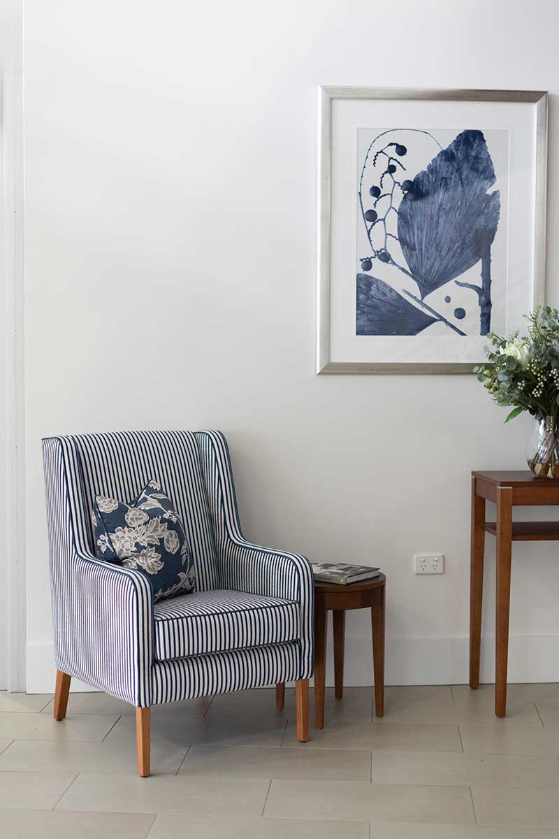 Armchair with cushion and side table in retirement village