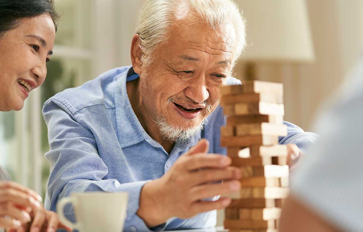 elderly man playing game in aged care